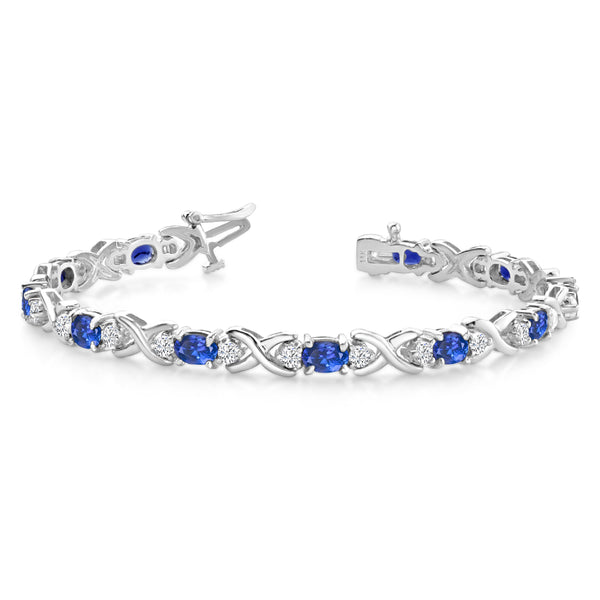 Reeds Jewelers 14K White Gold Aquamarine and Tanzanite Tennis Bracelet with  Diamond Halo, TDW 1.06